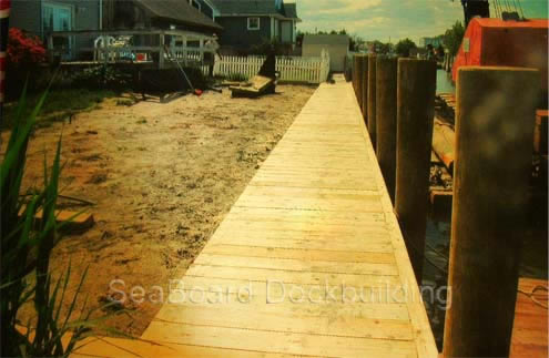 a wooden deck along the water's edge