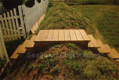 wooden steps over a protective hill of dirt